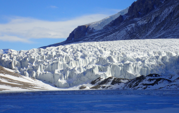 Glacier next to mountains.